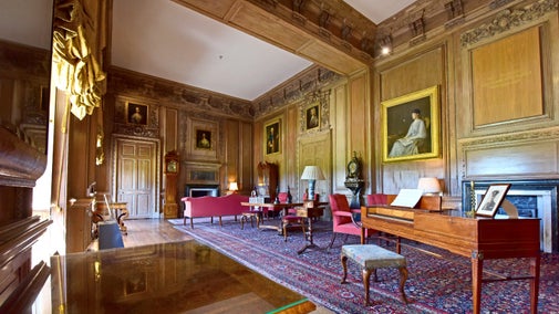 A large historic room full of furniture